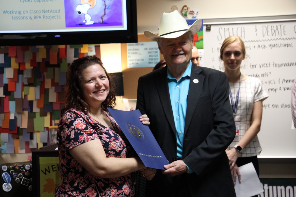 Representative Doc Anderson congratulated Susan Jones with a surprise classroom visit and House of Representatives Resolution.