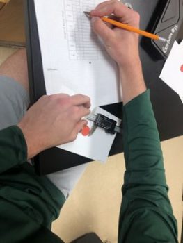 student using digital caliper