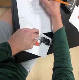 student using digital caliper